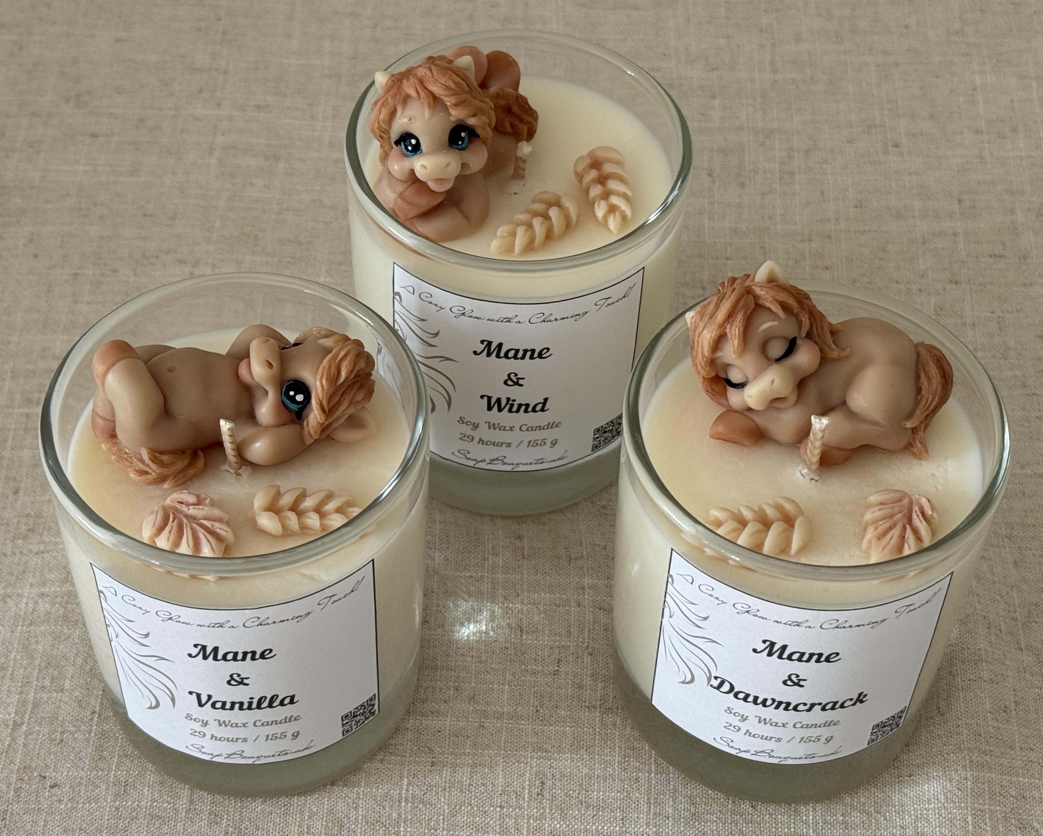 Three handmade horse candles with playful, peeking and sleeping horse designs – soy wax equestrian gifts for horse lovers
