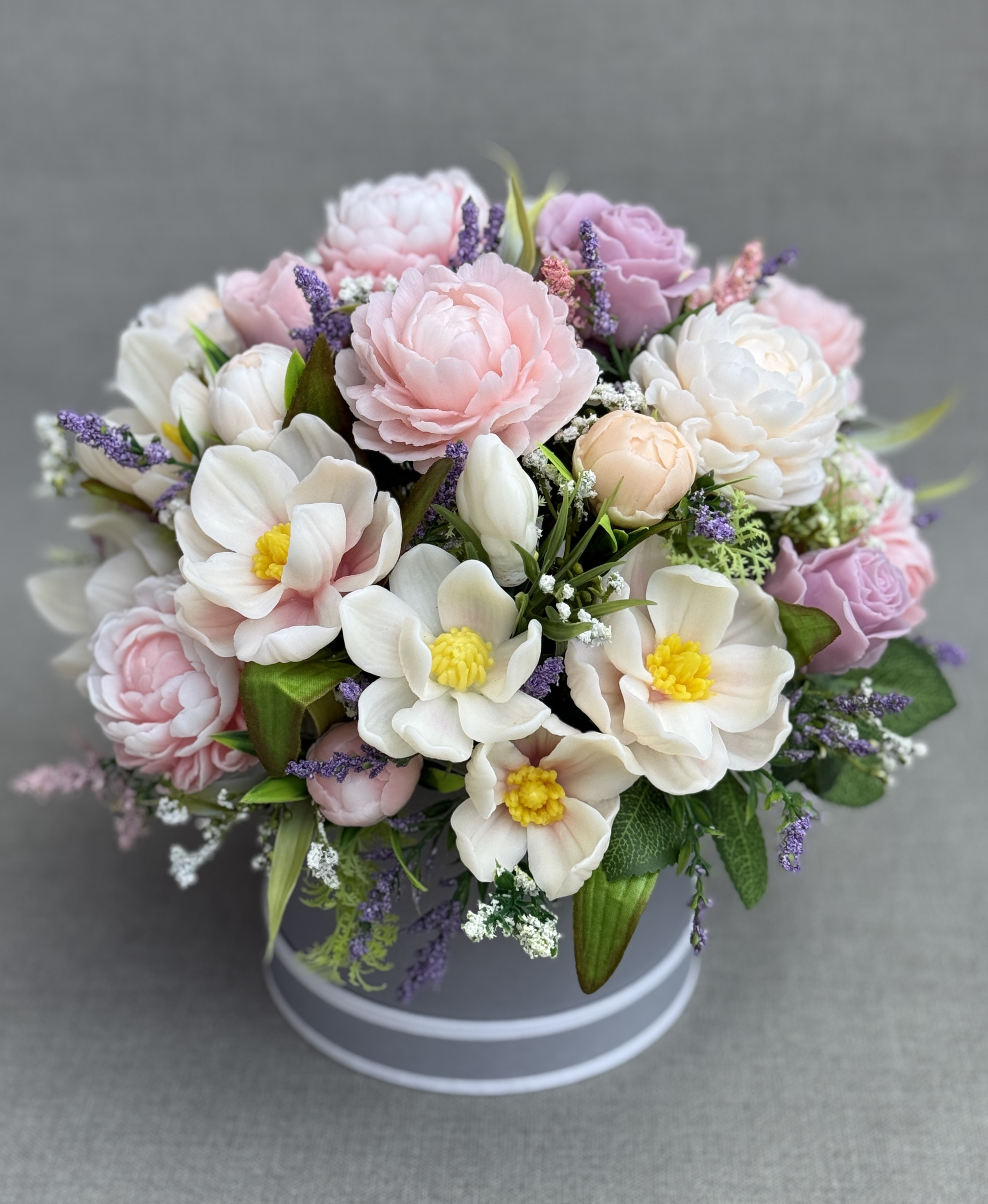 Side view of a pastel soap flower bouquet featuring cream magnolias, pink peonies and lilac roses.