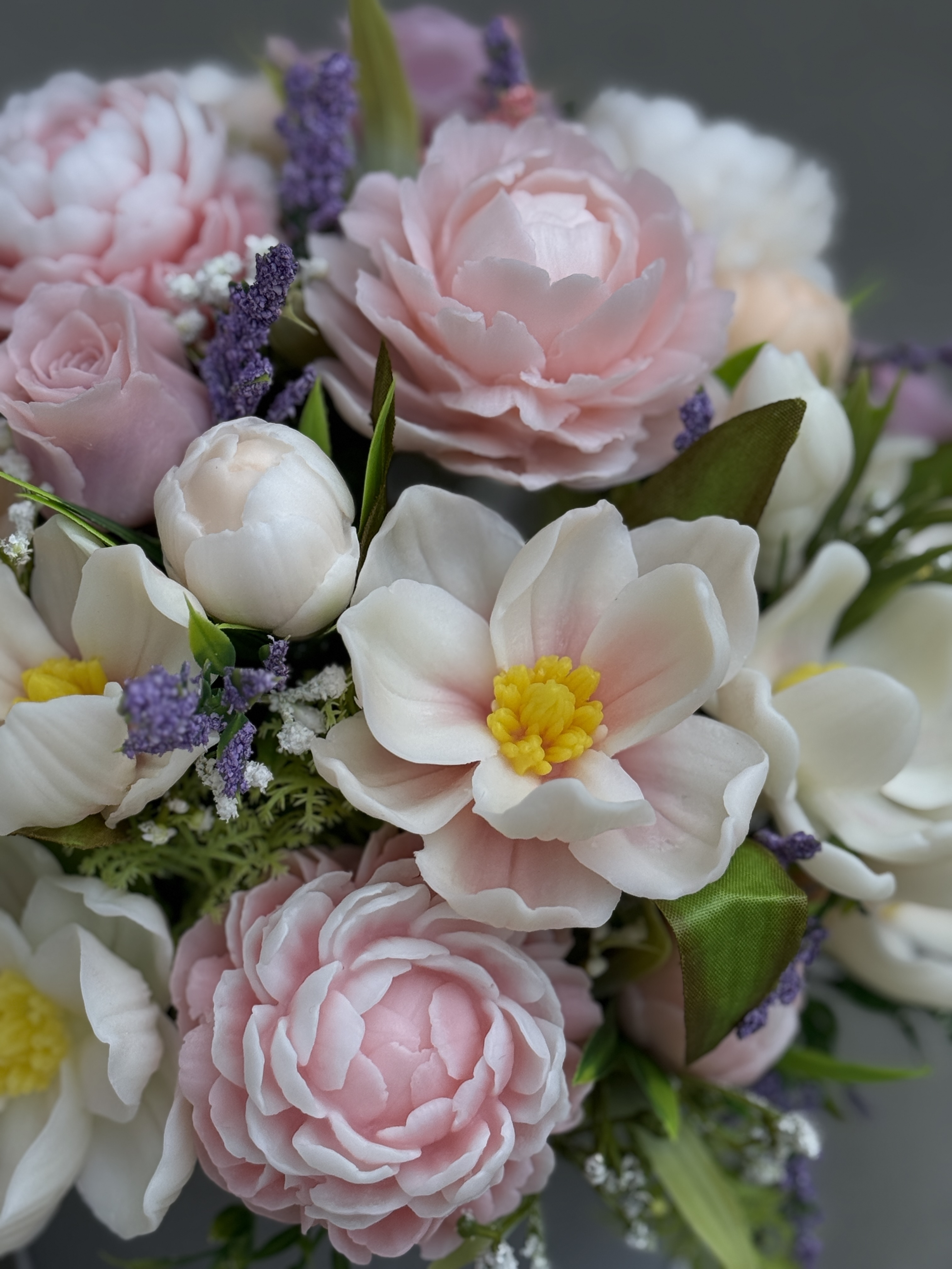 Close-up of handcrafted pink peony, lilac rose and cream magnolia soap flowers.