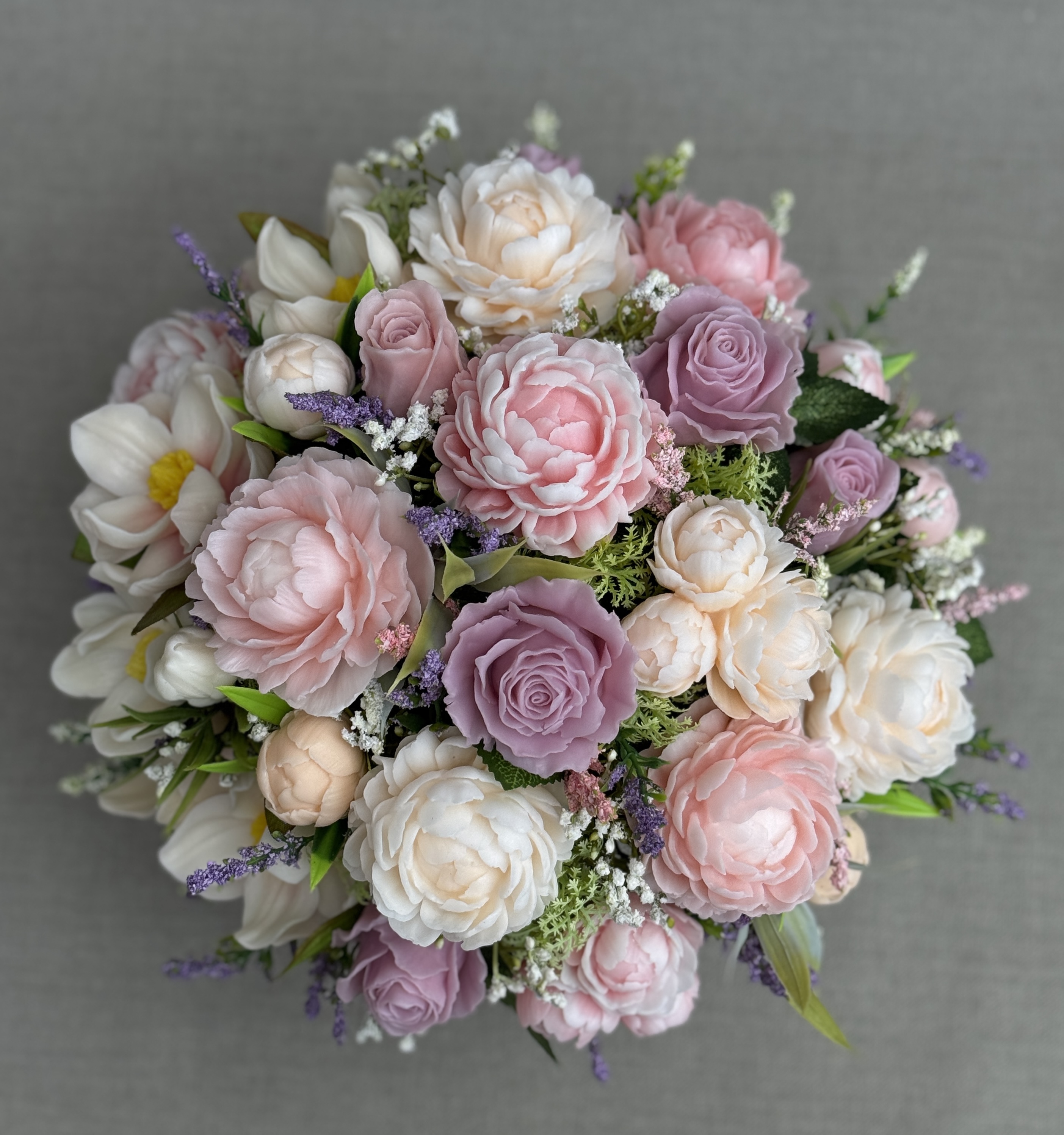Top view of a large handmade soap flower bouquet with pastel pink, cream and lilac flowers.