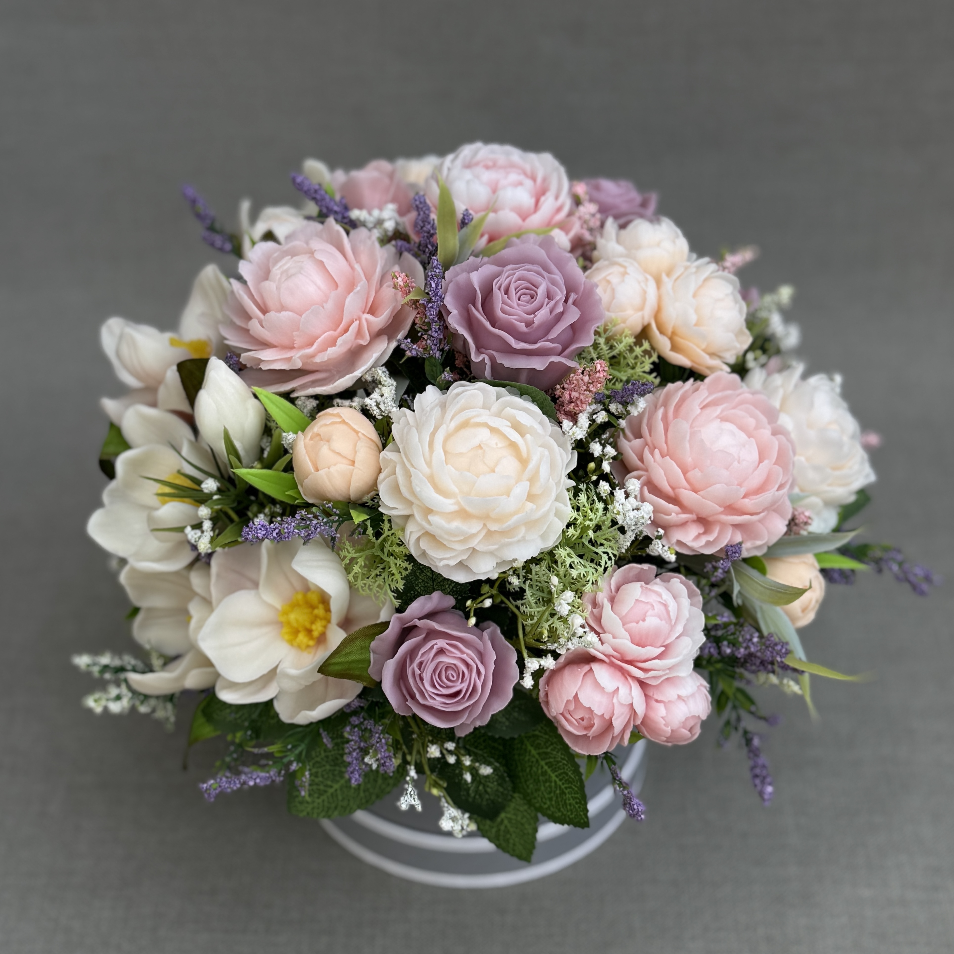 Side view of a handmade pastel soap flower bouquet with pink peonies, lilac roses and cream magnolias.
