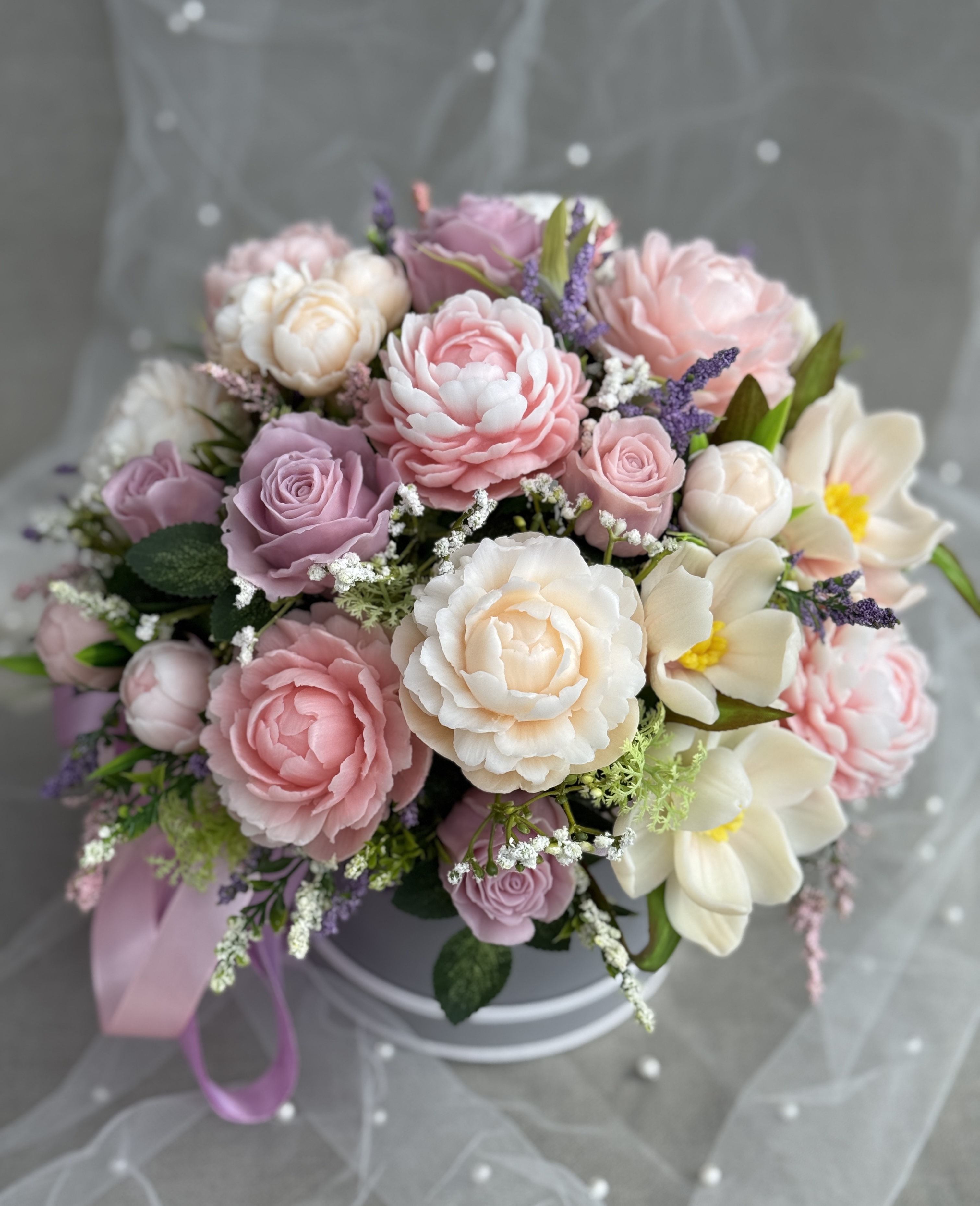 Pastel soap flower bouquet styled with pearl-dotted tulle as an elegant wedding gift.