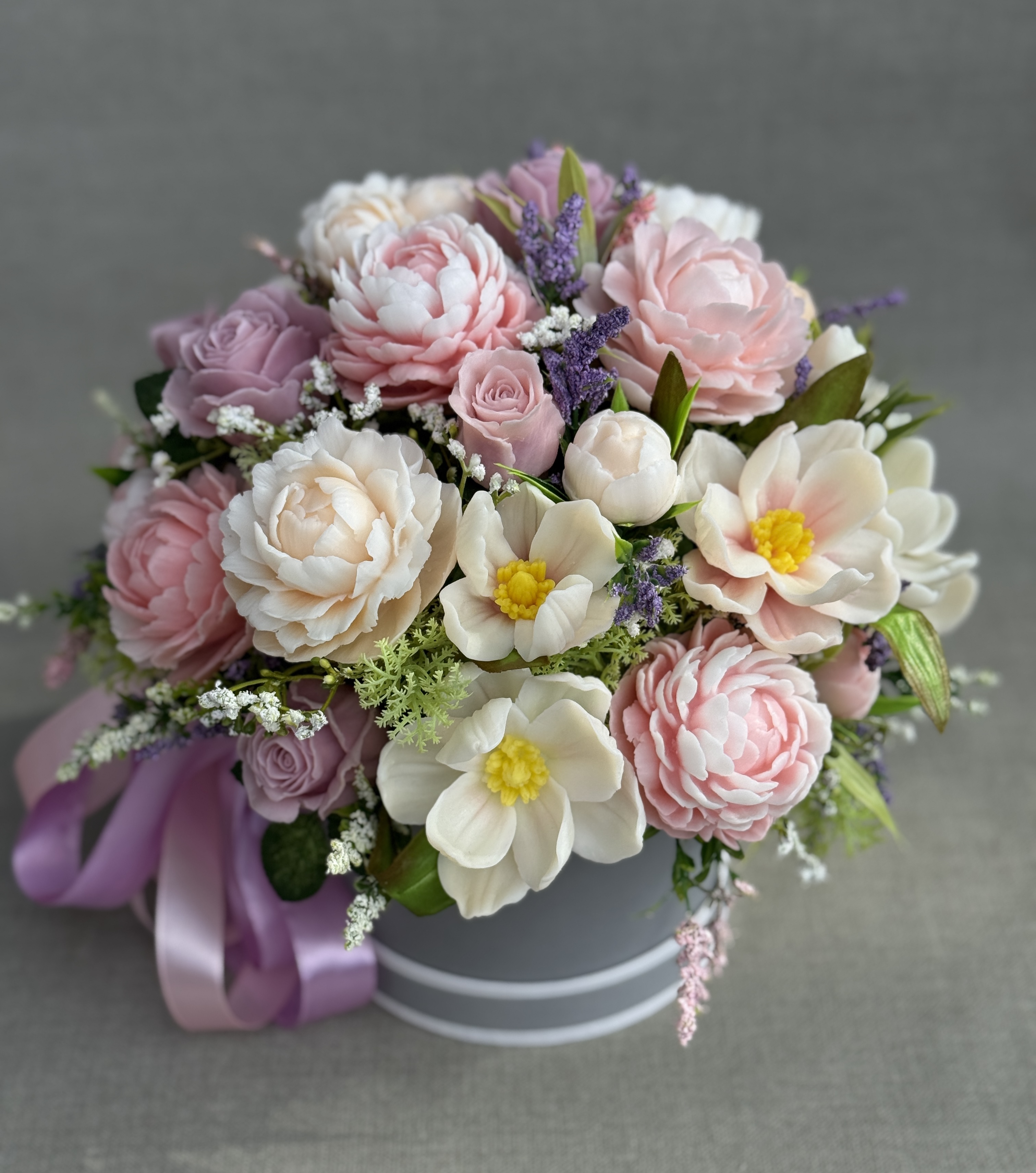 Pink and cream soap flower bouquet with peonies, roses and magnolias, finished with a lilac satin bow.